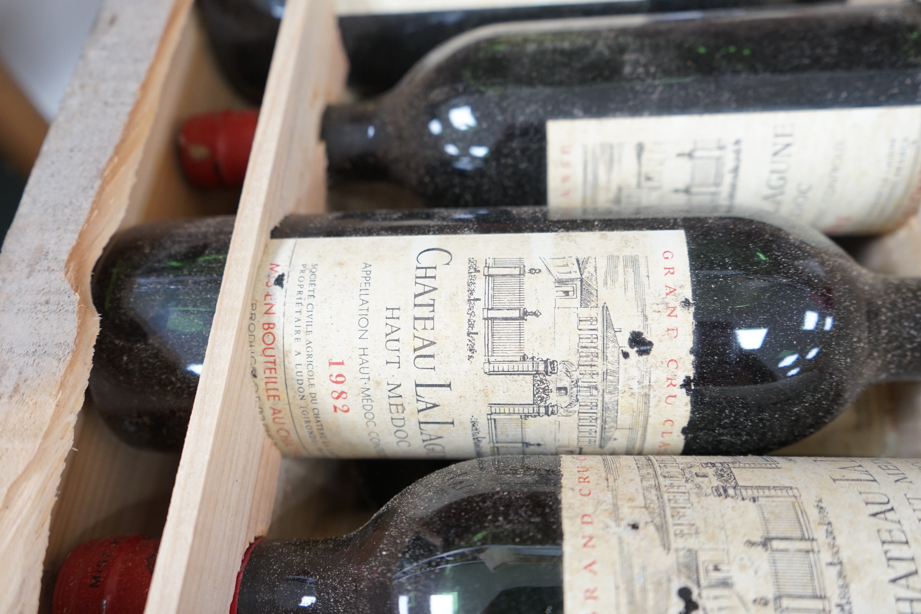 A case of twelve Chateau La Lagune, Haut-Medoc, 1982, France, OWC. Condition - fair, lacking cover. Storage history unknown